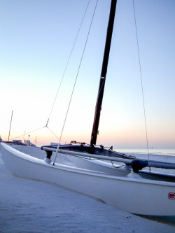 Catamaran beached on the Panama City Beach Gulf Coast at sunrise.
boats sail